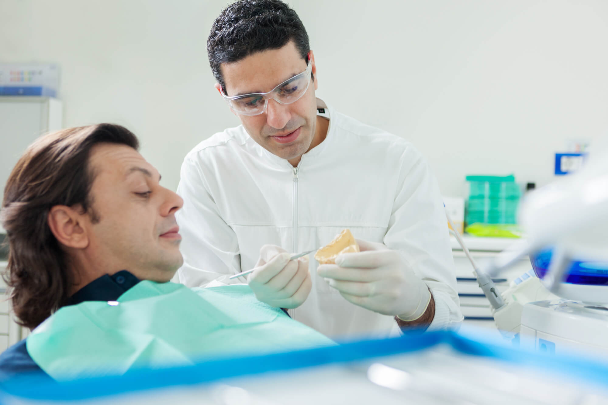 dentist showing patient a Las Vegas dental crowns