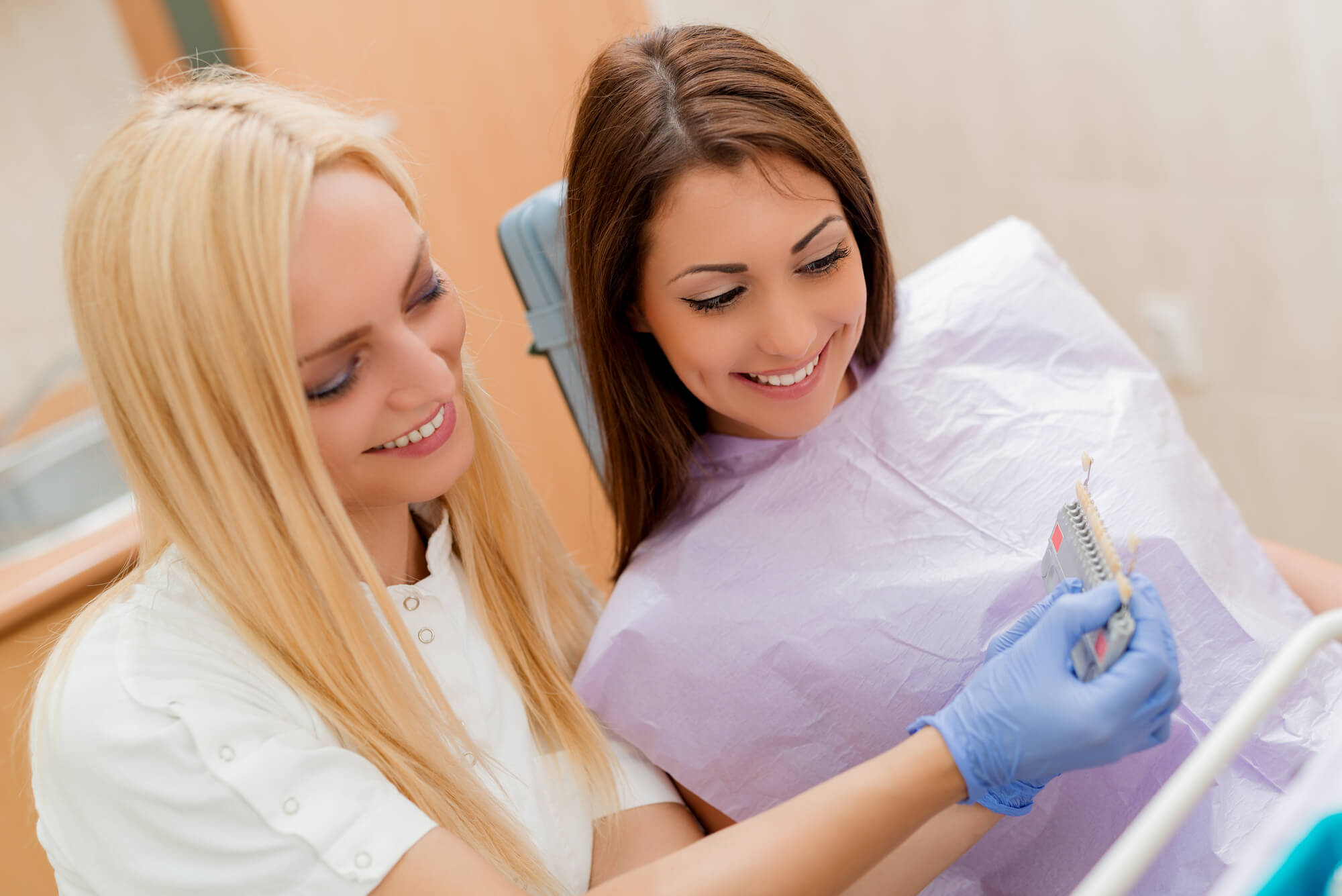 Dentist and patient in Las Vegas choosing the shade of dental veneers