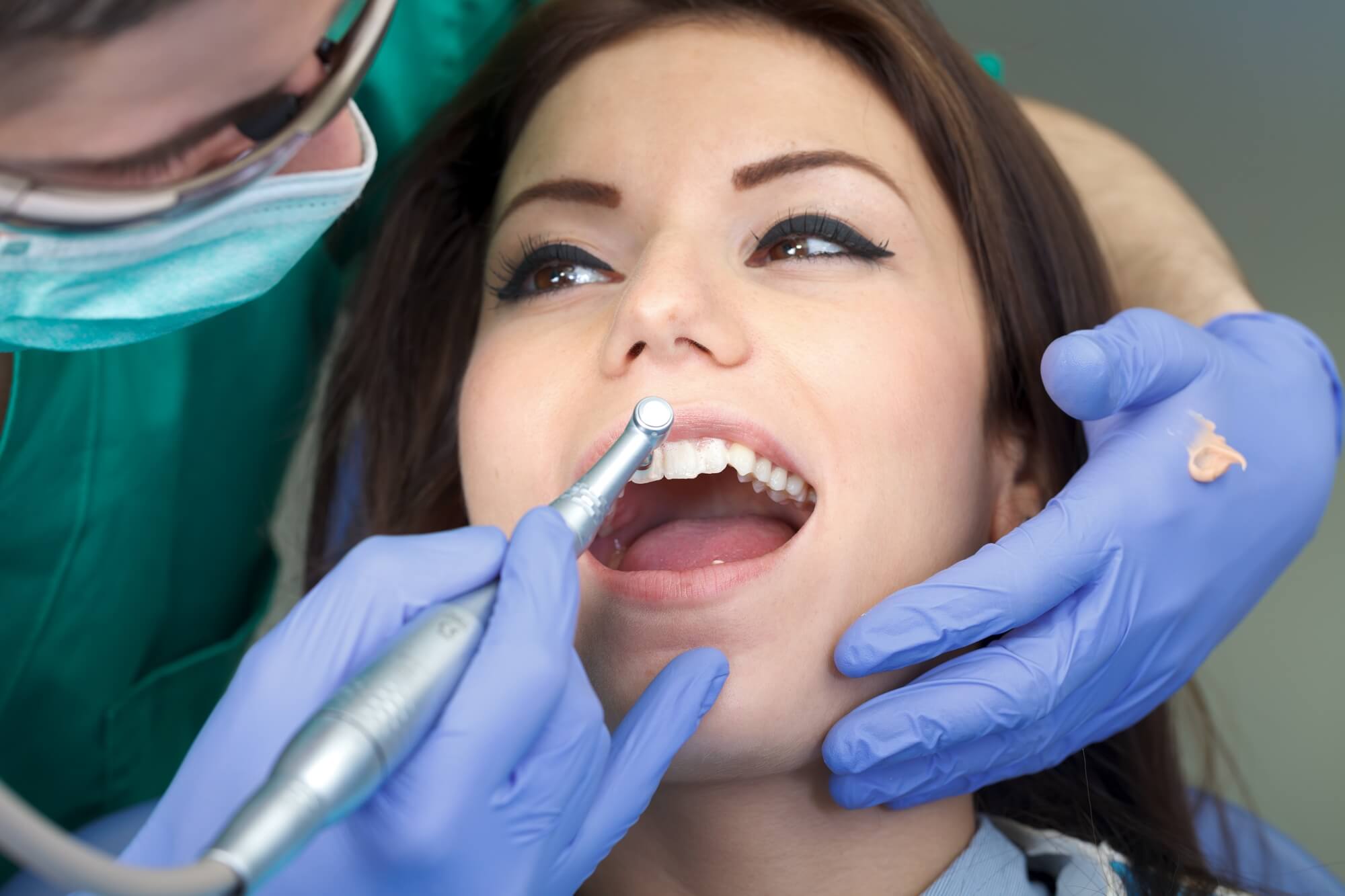best dentist in summerlin cleans patient's teeth