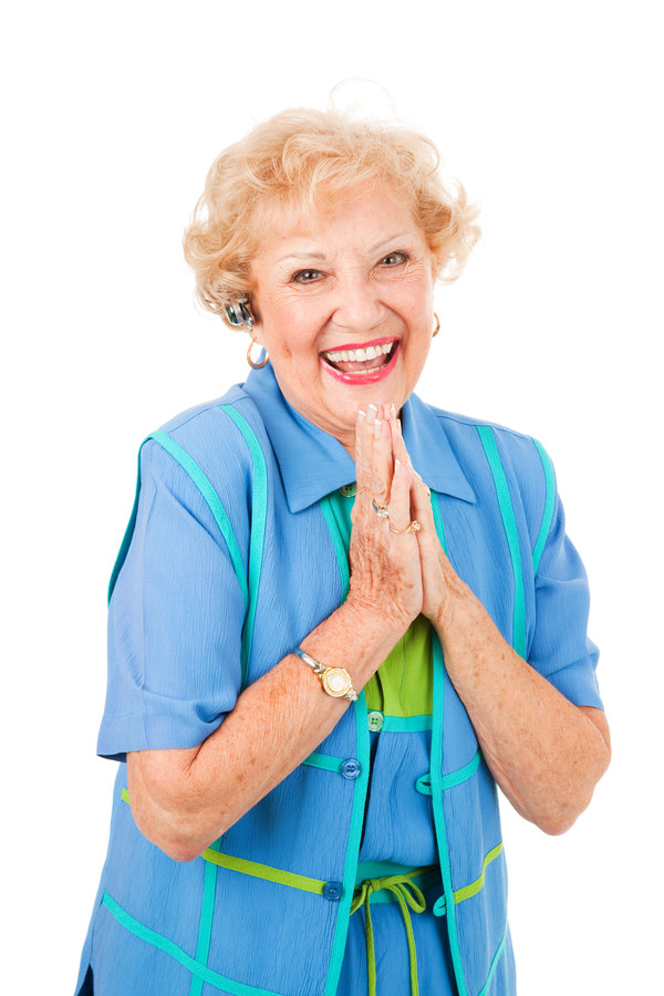 Ecstatic senior woman gets good news by phone, over her hands free set. Isolated on white.