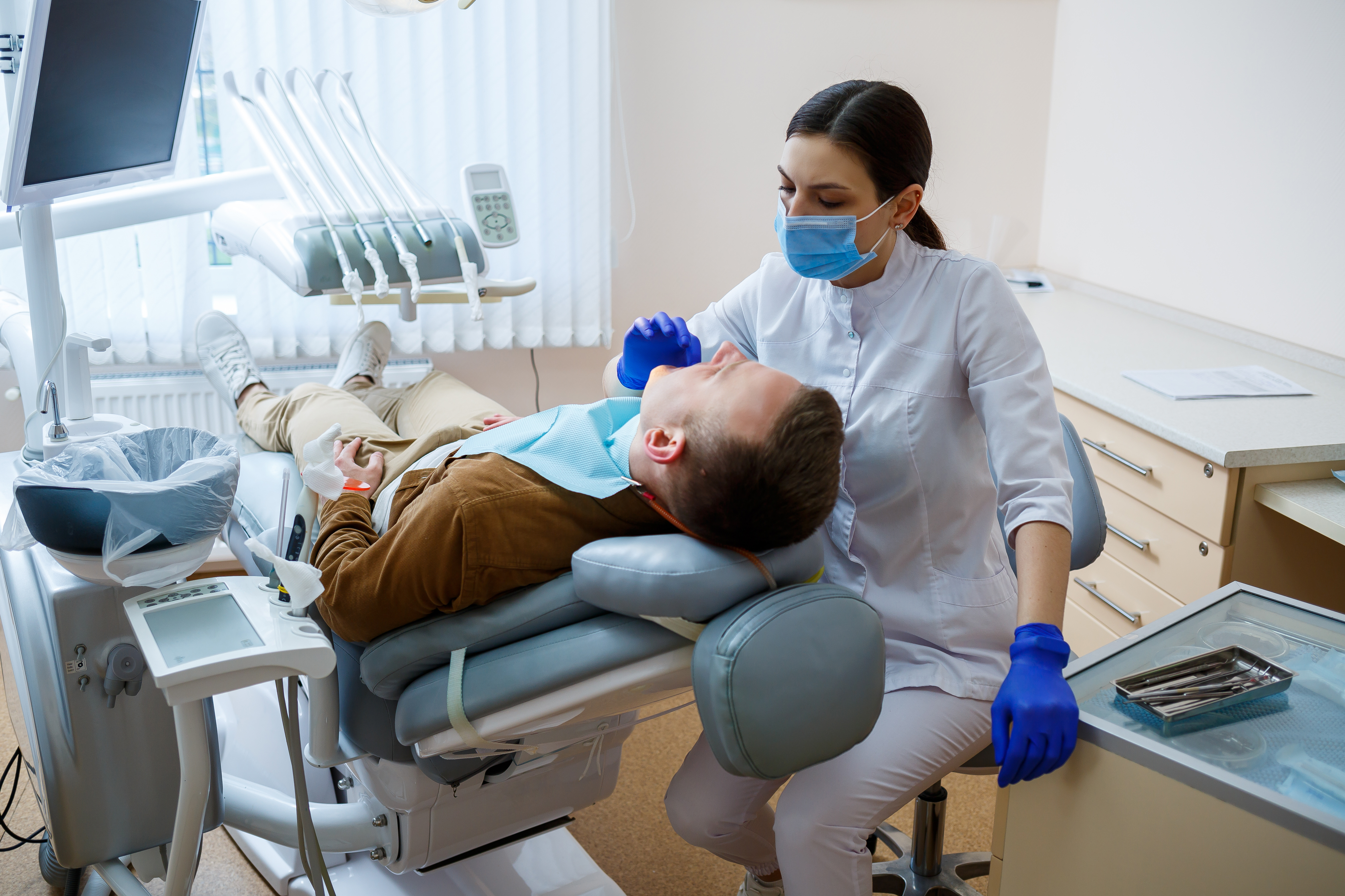 Dentist treating an adult patient with special needs during a dental appointment