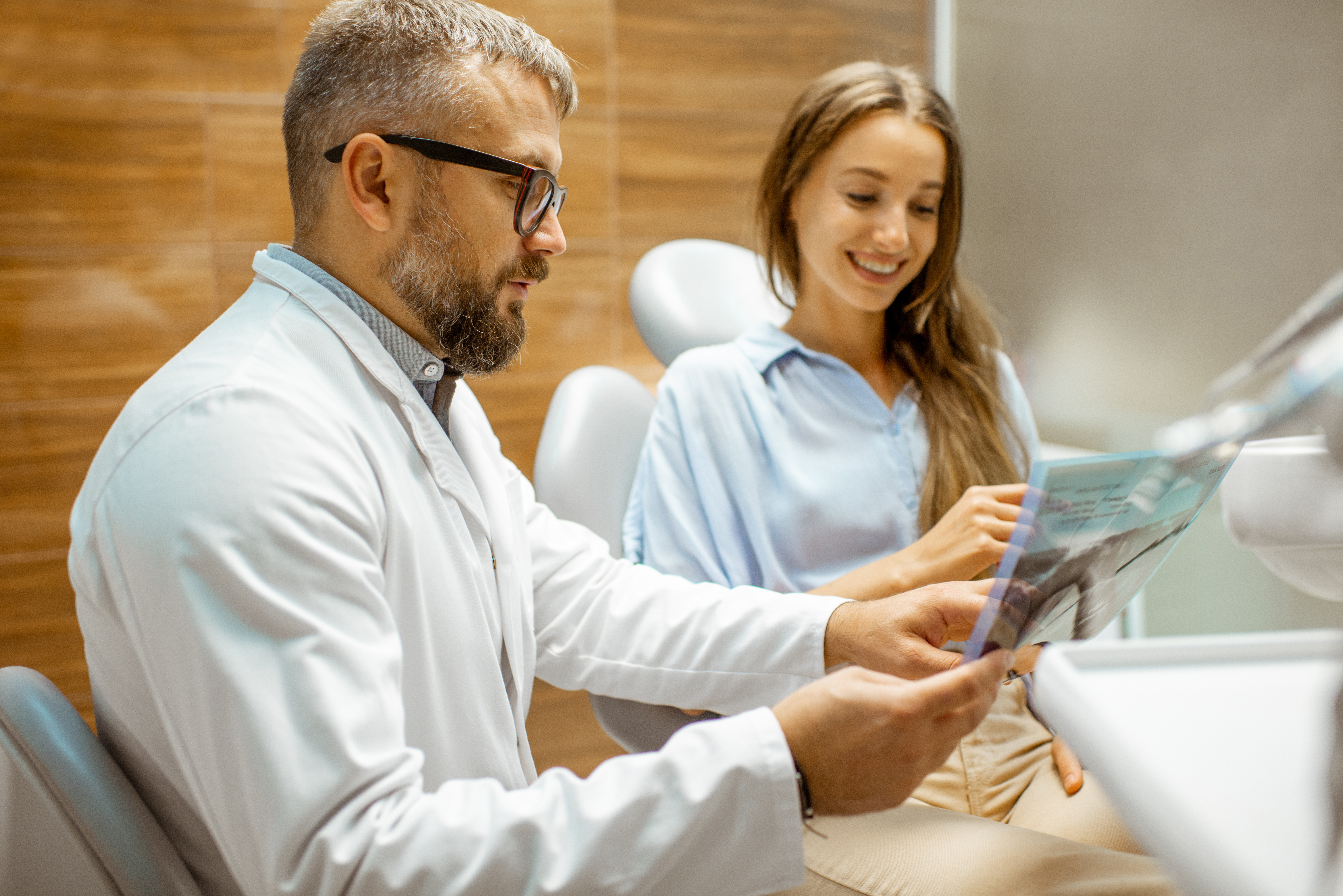 Dentist showing a patient an x-ray during a root canal consultation